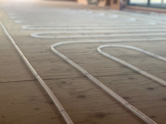 Close-up of radiant floor heating PEX tubing installation