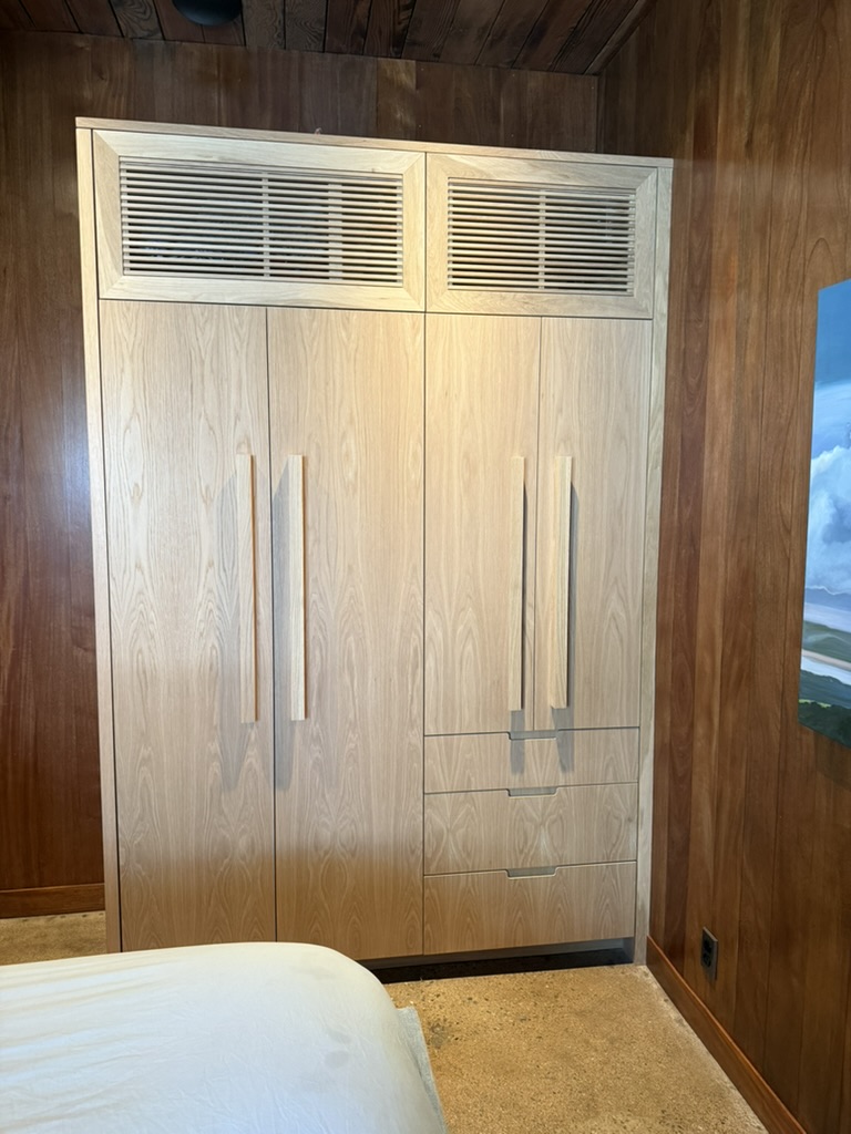 Bedroom cabinetry with integrated fan coil grilles