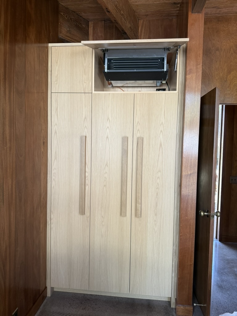 Concealed fan coil unit inside custom cabinetry