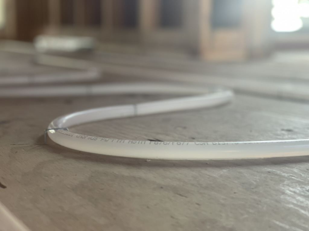 Close-up of PEX radiant tubing on subfloor